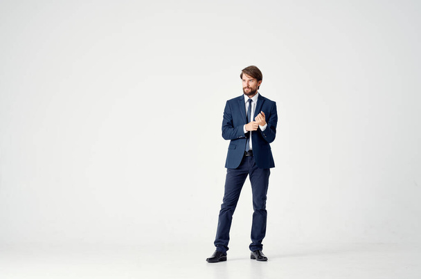 man in a suit posing on light background. High quality photo - Φωτογραφία, εικόνα
