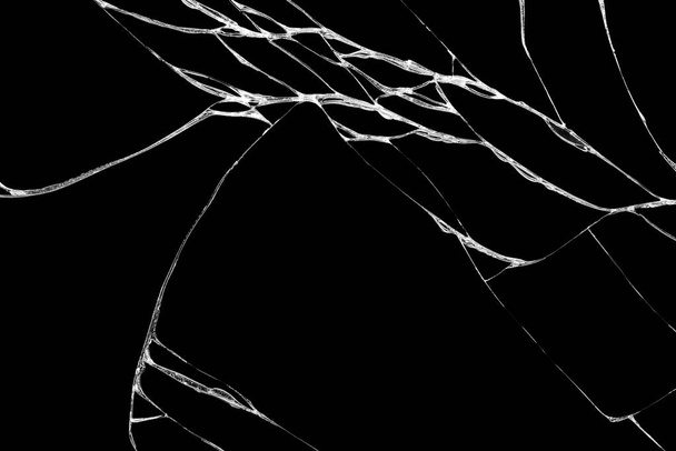 Kunst van rimpels en scheuren van glas veroorzaakt door knallende en vallende hobbels. geïsoleerd op zwarte achtergrond, Deze scheur kan worden gebruikt als een patroon van vloertegels, in een hoek betekent ook verlies en onenigheid - Foto, afbeelding