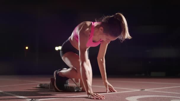 Woman hand on track as he crouches in starting position at the beginning of a race. Female Athlete Prepare And Start. Runner hands waiting at the start in front of the starting line at the ground. - 映像、動画