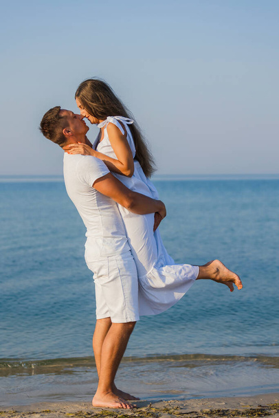 couple kissing on the background of the sea - Фото, зображення