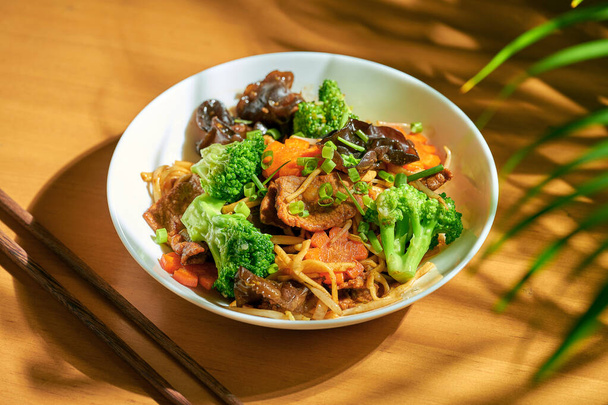 Wok noodles with vegetables and beef in a bowl. Chinese cuisine - Foto, immagini