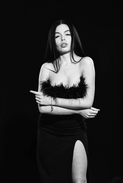 Fashion concept. Elegance in simplicity. Black is perfect. Glamorous style. Feather decorations. Elegant woman fashion model. Fashionable girl wearing dress with feathers. Fancy clothes. Fashion shop - Foto, afbeelding