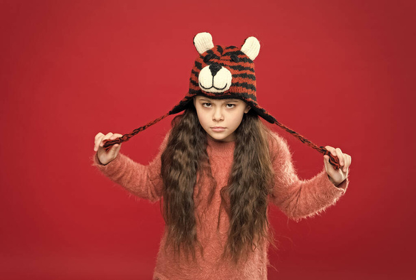 having no mood. stylish teen girl with long hair in earflaps. winter kid fashion. happy childhood. christmas time activity. holiday fun. cold season accessory. serious child in warm clothing - 写真・画像