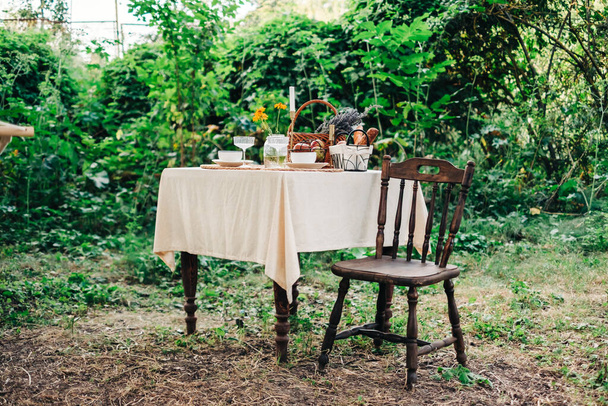 Dinner table in the backyard outdoors in countryside, nobody. - Φωτογραφία, εικόνα