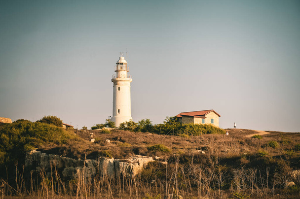 Landscape with white lighthouse based on the rocky hill - Foto, Imagen