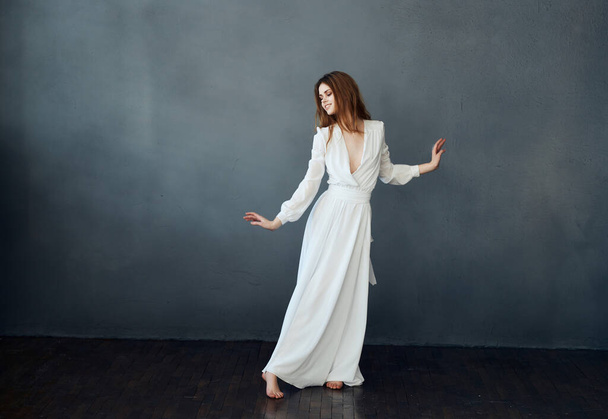 portrait of woman in white dress in full growth dancing - Fotoğraf, Görsel