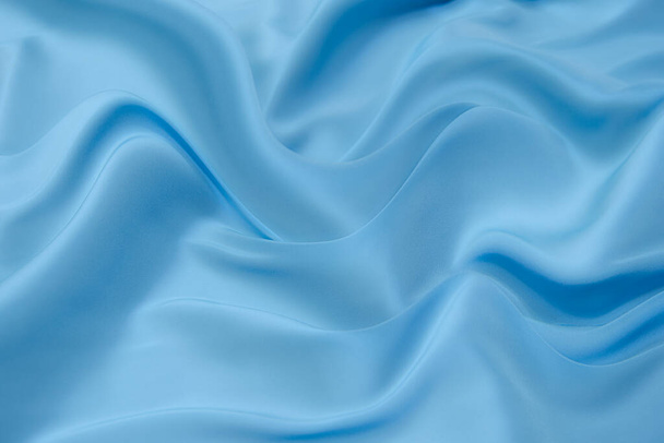 Голубая ткань текстура фона, волнистая ткань мягкий синий цвет, роскошный атлас или шелковая ткань текстура. - Фото, изображение