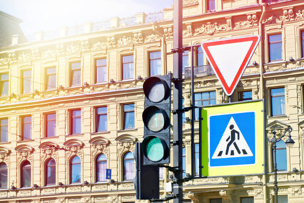 Traffic light and road signs on the background of an old city building - Photo, image