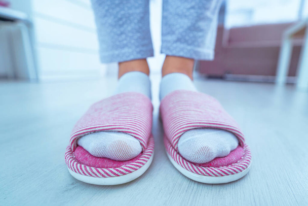 Female legs with cozy soft comfortable home slippers close-up  - Photo, image