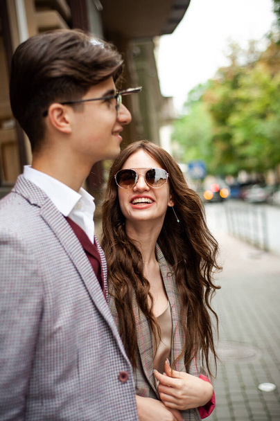 young couple in sunglasses on the street - 写真・画像