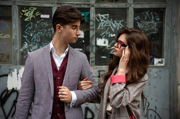 young couple in sunglasses and glasses posing outdoors - Photo, image