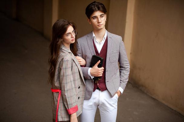 young couple in casual clothes and glasses on the street - Photo, Image