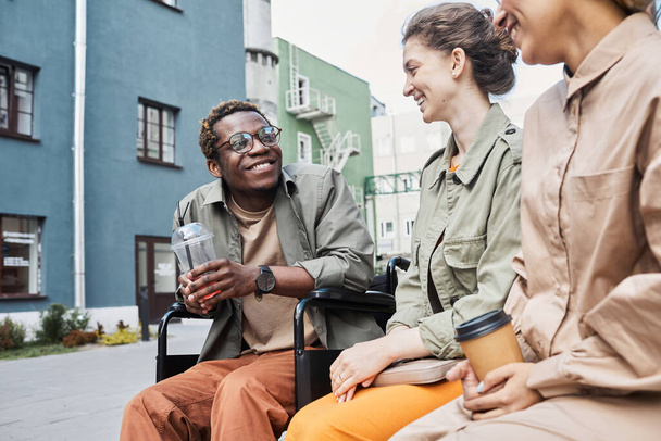 Cheerful black disabled man laughing with friends - Photo, Image