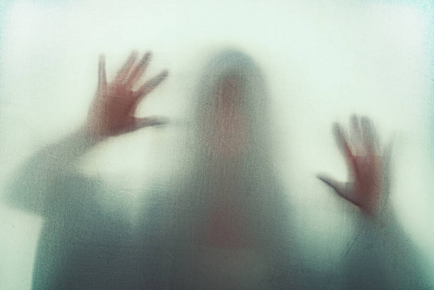 Shadow of scary paranormal ghost horror woman in soft focus. Blurry hand and body figure abstraction. - Foto, imagen