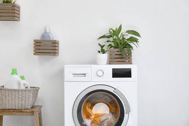 Modern washing machine with laundry in bathroom - Фото, изображение