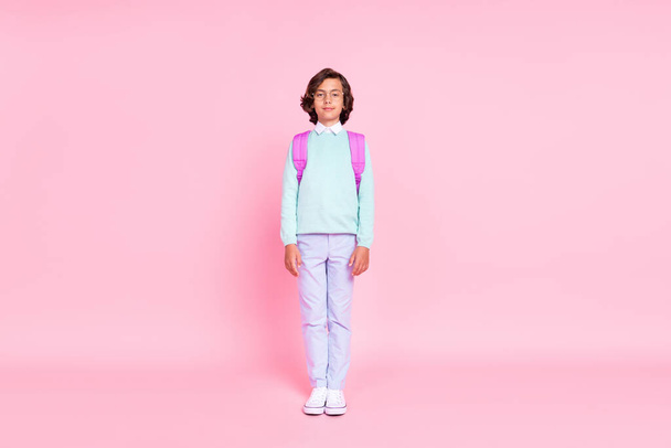 Photo of little schoolkid boy look camera smile wear backpack spectacles teal shirt isolated pink color background - Фото, зображення