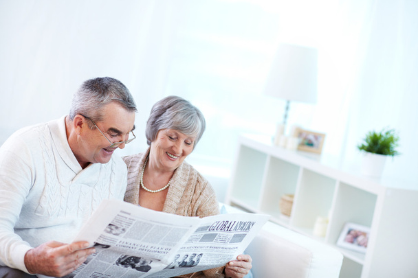 Couple of pensioners reading newspaper - Zdjęcie, obraz