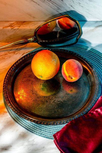 Fruit still life orange and peach with fancy drinking glass - Valokuva, kuva