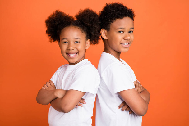 Profile photo of small funny girl boy crossed arms wear white t-shirt isolated on orange background - Φωτογραφία, εικόνα