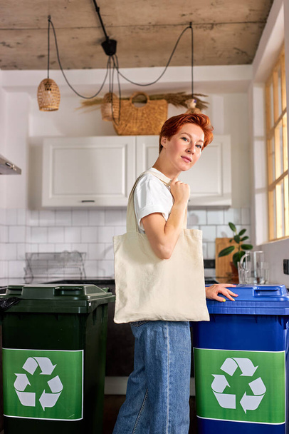 Female with Eco Shopping bag in room with waste bins. Environmental Protection, Zero waste - Valokuva, kuva