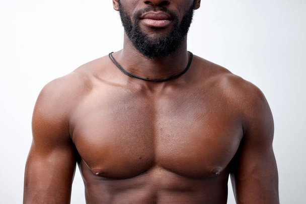 Cropped photo of strong muscular black man with naked torso, bodybuilder concept - Fotoğraf, Görsel