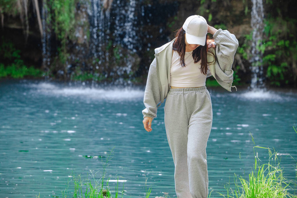 woman hiker enjoying view of waterfall summertime travel concept - Foto, imagen