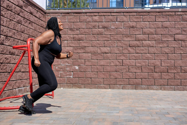 Fat woman and sports. african fat woman Does exercise for weight loss in fresh air - Photo, image