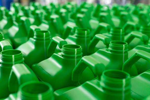 Empty plastic cans green color for liquids. Concept: Manufacturing - Photo, Image