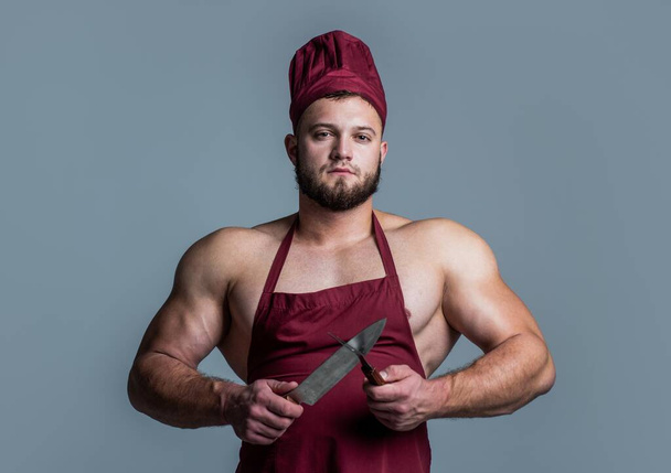 muscular man butcher in chef apron hold knife kitchen utensil, cooking - Fotografie, Obrázek