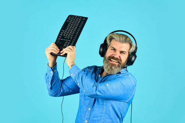 hacker typing. communication concept. support, call center and customer service help desk. gamer playing computer game. Digital Music Creation. angry man listen headphones and keyboard - Photo, Image