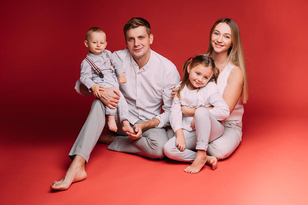 happy family of four rejoice together in the studio - Fotó, kép
