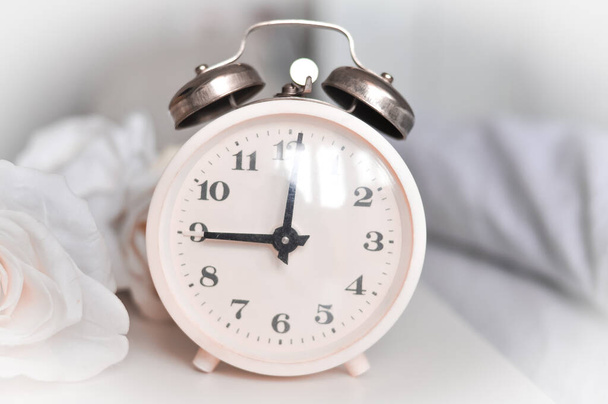 белый будильник в спальне на дому в moning, время просыпаться, время деньги - Фото, изображение