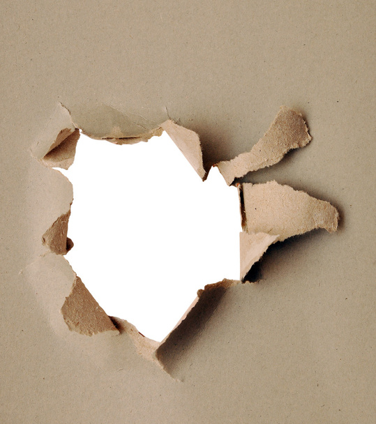 zerrissenes Papier - graue Pappe zerrissen, die darunter liegende Schicht zeigt - Foto, Bild