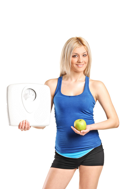 Young woman holding weight scale - Foto, immagini