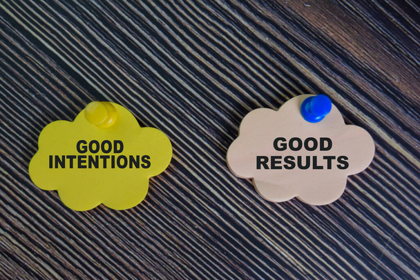 Good Intentions or Good Results write on sticky notes isolated on Wooden Table. - Photo, Image