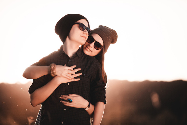 Young fashion hipster couple in love kissing and having passion in spring sunny weather - Fotoğraf, Görsel