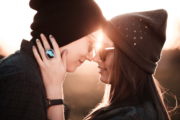 Young fashion hipster couple in love kissing and having passion in spring sunny weather - Foto, afbeelding