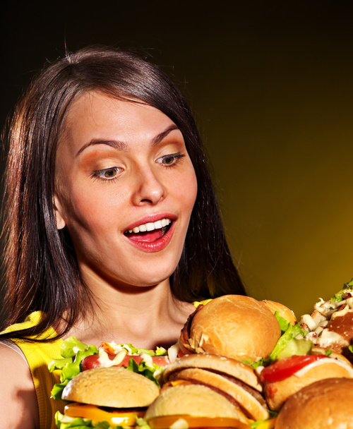Thin woman holding hamburgers. - Photo, Image