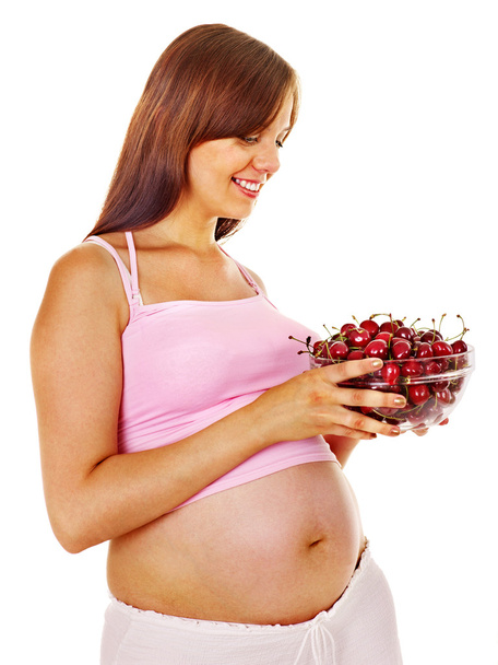 Femme enceinte mangeant des fruits
. - Photo, image