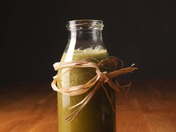Healthy vegetable fruit smoothie from organic ingredients on a wooden kitchen table - 写真・画像