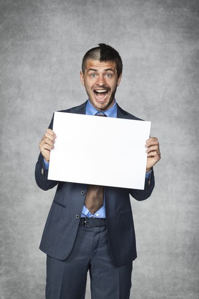 Happy businessman holding a sheet of paper - 写真・画像