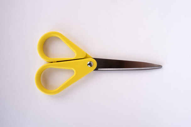 Closed yellow scissors on a white background - Foto, Imagem