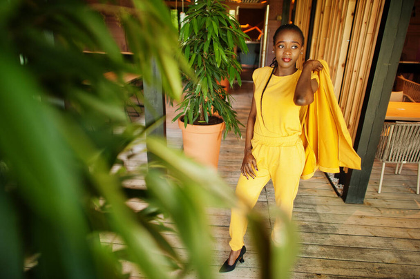 Portrait of nice-looking fashionable attractive lovely content cheerful cheery african american girl wear bright vivid shine vibrant yellow color jacket or costume. - Фото, зображення