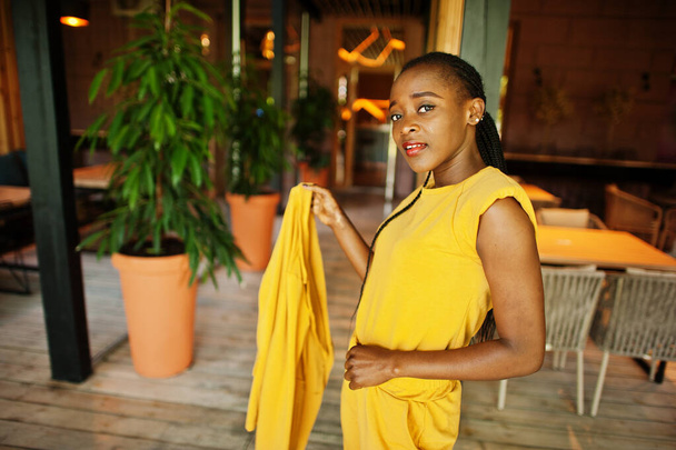 Portrait of nice-looking fashionable attractive lovely content cheerful cheery african american girl wear bright vivid shine vibrant yellow color jacket or costume. - Foto, immagini