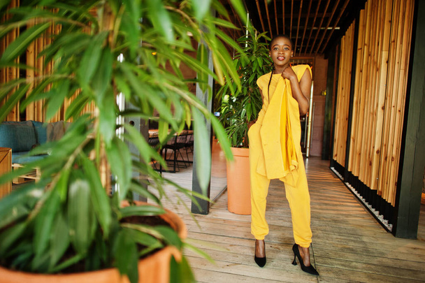 Portrait of nice-looking fashionable attractive lovely content cheerful cheery african american girl wear bright vivid shine vibrant yellow color jacket or costume. - Foto, imagen