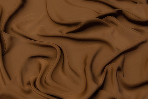 Texture en gros plan de tissu brun naturel ou de tissu de même couleur. Texture du tissu en coton naturel, soie ou laine, ou matière textile de lin. Fond toile velours. - Photo, image