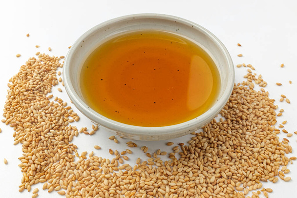 Cooking oil made from sesame seeds. Oil in food. Fragrant oil - Photo, Image