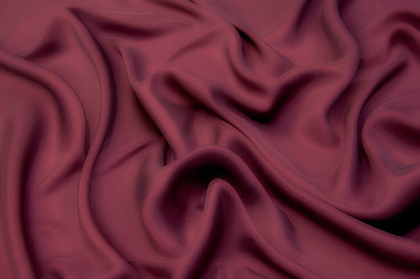 Крупним планом текстура натуральної червоної або рожевої тканини або тканини одного кольору. Тканинна текстура натуральної бавовни, шовку або вовни, або лляного текстильного матеріалу. фон з червоного полотна
. - Фото, зображення