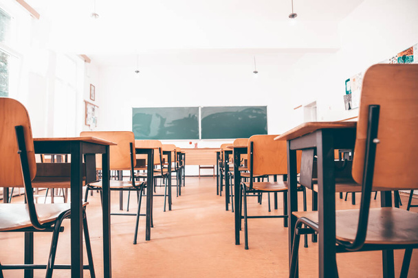 Back to School Concept. Empty classroom with chairs, desks and chalkboard. - 写真・画像