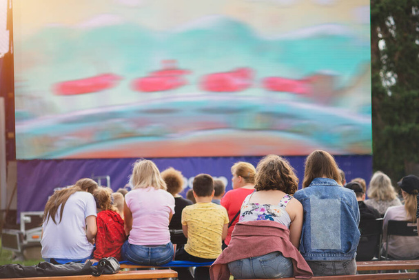 Children in summer cinema watching cartoon. - Фото, зображення